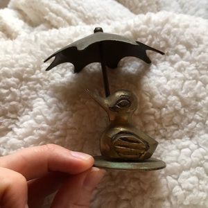 Brass duck and umbrella decor